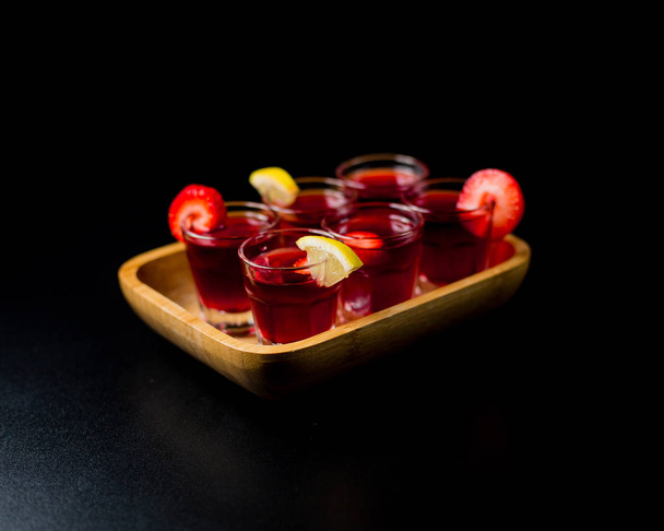 Shots of alcohol topped with various fruits - Foto, immagini