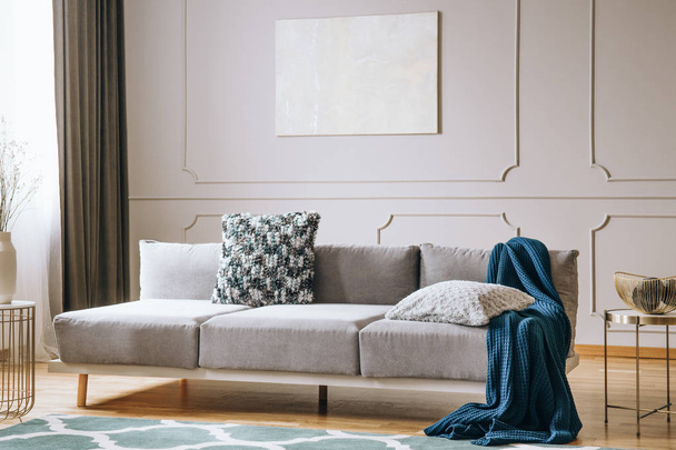 Blue blanket on grey couch in elegant living room interior - Фото, зображення
