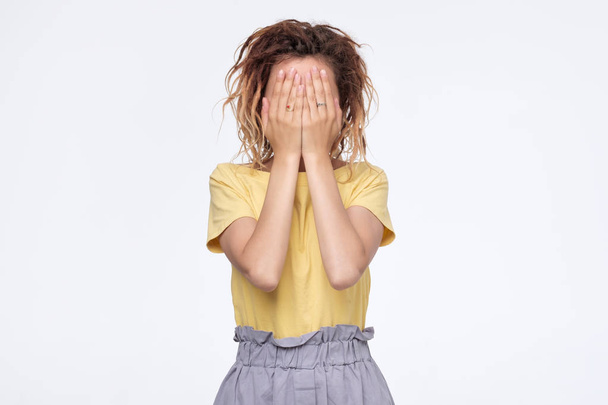 Ethnic young woman with dreadlocks hiding face - Photo, image