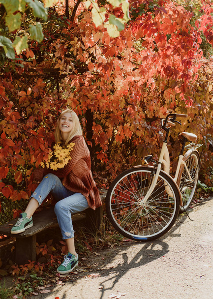 Autumn simple pleasures. Active leisure and lifestyle. Girl ride bicycle for fun. Blonde enjoy relax park. Autumn bouquet. Warm autumn. Girl with bicycle and flowers. Woman bicycle autumn garden - Fotografie, Obrázek