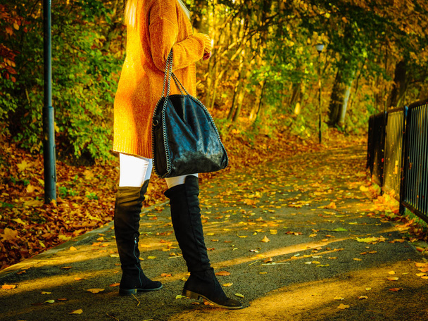 Woman wearing orange autumn cardigan outdoor - 写真・画像