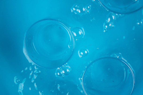 Glass of water on blue background - Фото, зображення