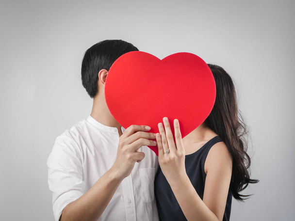 Happy couple in love holding red heart shape, valentine concept. - Fotoğraf, Görsel