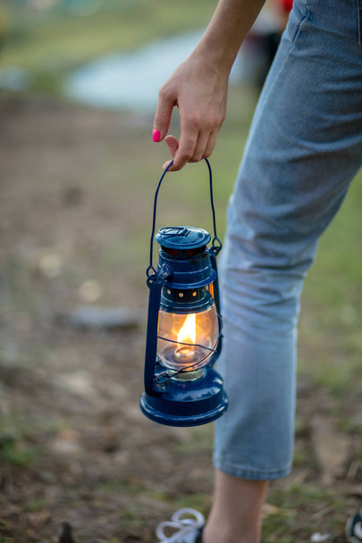 hiker girl holding old lantern. - Фото, зображення