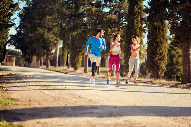 Young friends jogging in nature. healthy lifestyle - Foto, imagen