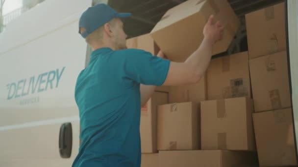 Courier Opens Delivery Van Side Door and Takes out Cardboard Box Package, Closes the Door and Goes on Delivering Postal Parcel. Slow Motion - Footage, Video
