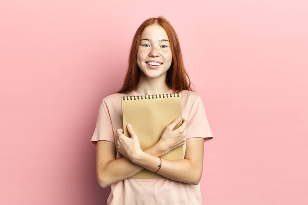 Portrait of intelligent cute clever happy female student with notebook - Photo, Image