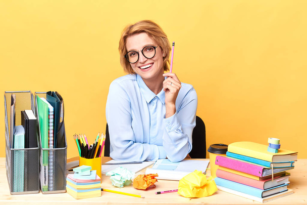 happy woman in shirt holding a pencil - Photo, image