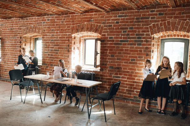 Young business boys and girls working in the office with loft interior - Zdjęcie, obraz