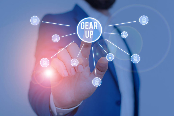Writing note showing Gear Up. Business photo showcasing Asking someone to put his clothes or suit on Getting ready fast Male wear formal work suit presenting presentation smart device. - Photo, image