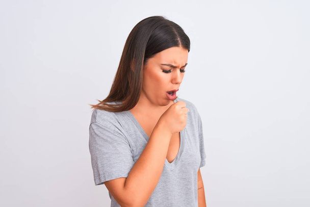 Portrait of beautiful young woman standing over isolated white background feeling unwell and coughing as symptom for cold or bronchitis. Healthcare concept. - Photo, image