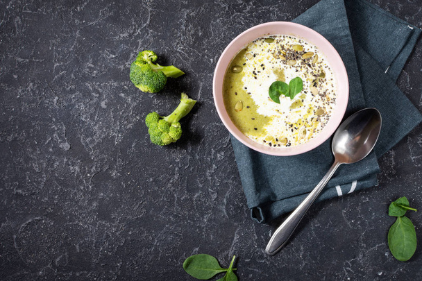 Soupe à la crème de brocoli et ingrédients sur table en pierre noire
 - Photo, image