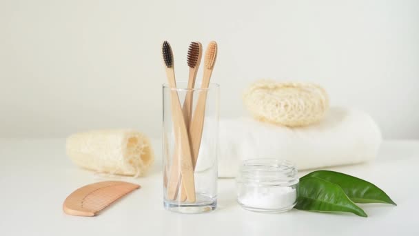 Woman hand take bamboo wooden toothbrush from glass in bathroom. Zero waste and hygiene concept - Footage, Video