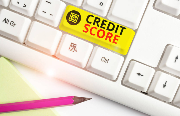 Text sign showing Credit Score. Conceptual photo creditworthiness of an individual based on credit files White pc keyboard with empty note paper above white background key copy space. - Photo, Image