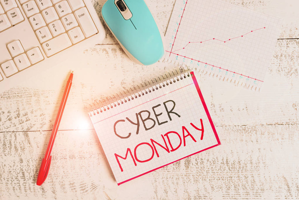Conceptual hand writing showing Cyber Monday. Business photo text Monday after the Thanksgiving holiday Online shopping day Wood desk office appliance computer equipaments charts paper slot. - 写真・画像