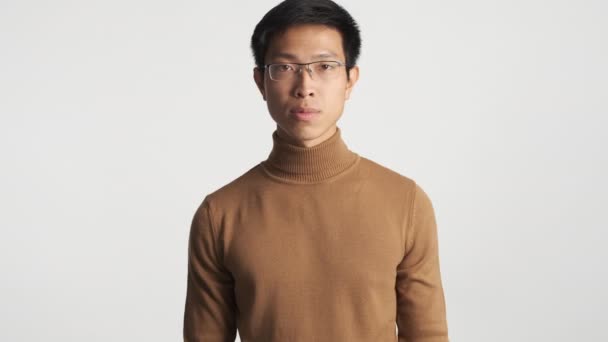 Young afraid asian man in eyeglasses scared looking in camera isolated. Wow expression - Footage, Video