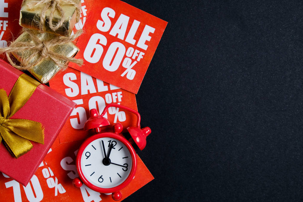 Vintage watch with gift boxes on red plates with discounts on a whatman paper in black. Christmas sale concept. - Fotoğraf, Görsel