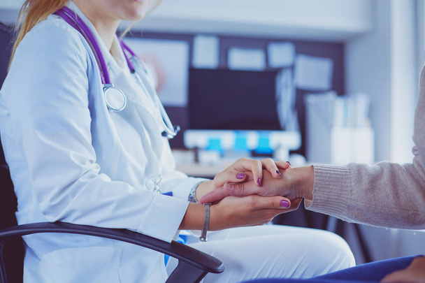 Woman doctor helping senior holding hand in hospital - Фото, изображение