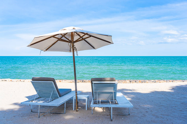 Beautiful umbrella and chair around beach sea ocean with blue sk - Valokuva, kuva