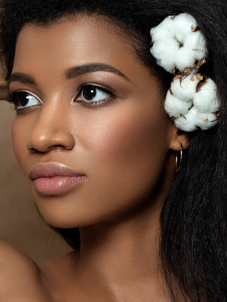 Young beautiful black woman with cotton flowers - Фото, изображение