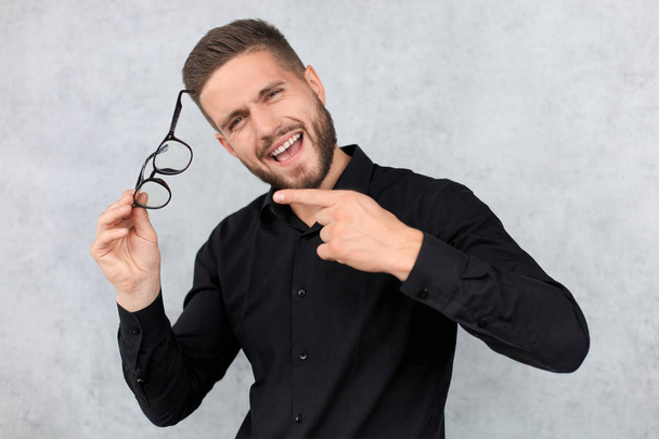 Attractive man dressed casual, wearing glasses - studio shot, copy space - Photo, Image