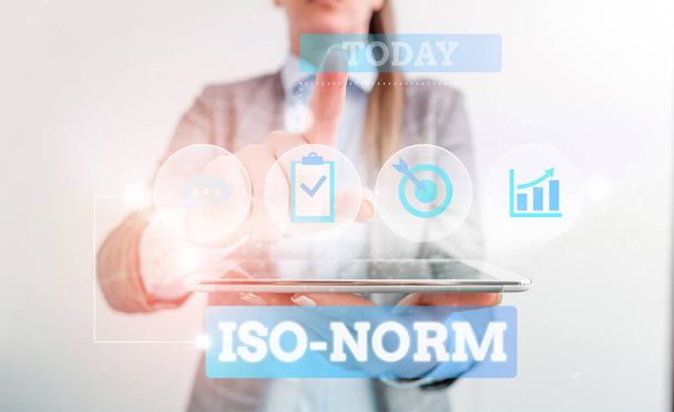 Text sign showing Iso Norm. Conceptual photo An accepted standard or a way of doing things most showing agreed Female human wear formal work suit presenting presentation use smart device. - Fotó, kép