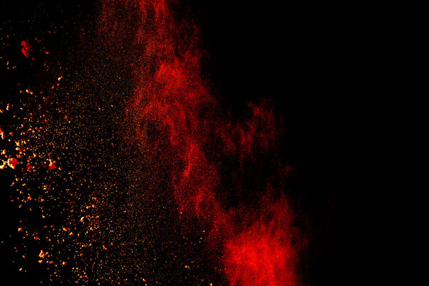 Red orange color powder explosion cloud isolated on black background. - Fotoğraf, Görsel