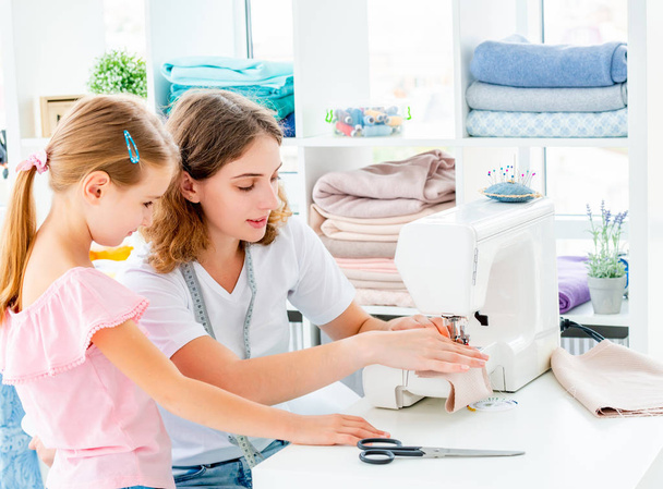 Little girl is taught to sew - Photo, Image