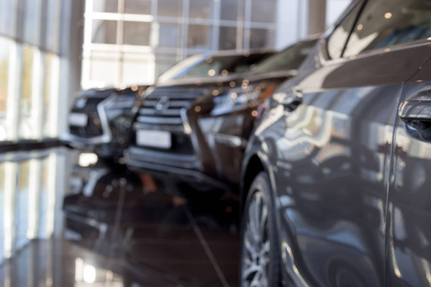 Car auto dealership.Themed blur background with bokeh effect. New cars at dealer showroom. - Fotografie, Obrázek