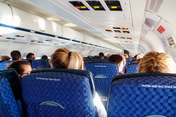 Interior of the airplane with passengers on seats - Valokuva, kuva