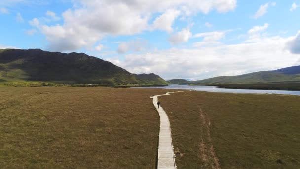 This is an aerial shoot of a person walking the Claggan Mountain Coastal Trail which is part of the Ballycroy National Park in County Mayo Ireland - Footage, Video