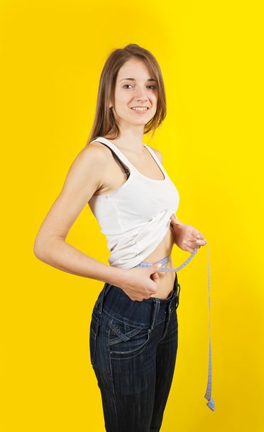 Girl measuring waist - Foto, immagini