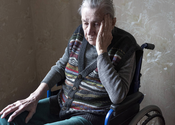  Old woman in a wheelchair. Loneliness, old age, health problems, problems with memory. - Photo, Image
