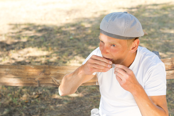 Man rolling a cigarette sealing the paper - Fotografie, Obrázek