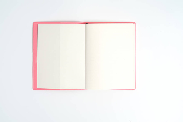 Pink notebook on white desk. Business minimal concept for women. Flat lay, top view, copy space - Fotoğraf, Görsel