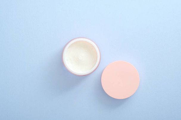 Moisturizing care skincare face cream in an open jar. Flat lay, top view, overhead. Skin care, beauty and healthcare concept. - Fotó, kép