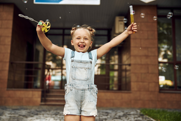 Excited child outdoors with soap bubbles stock photo - Fotografie, Obrázek