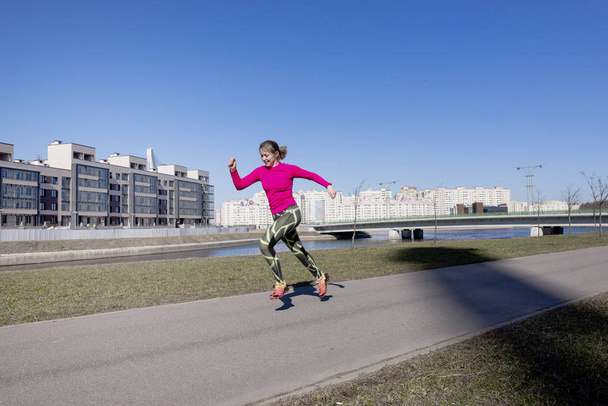 1 white chubby woman running in the city along the embankment, r - 写真・画像