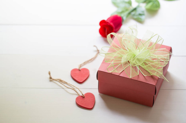Regalo de regalo con flor de rosa roja y caja de regalo con cinta de lazo a
 - Foto, imagen