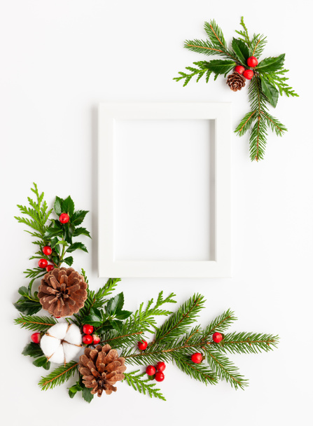 Christmas composition  with photo frame, cotton flower, branches - Photo, Image