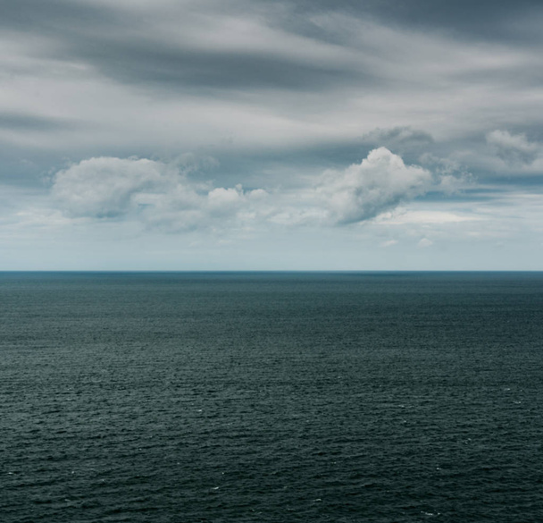 ocean and sky landscape with expressive clouds - Photo, Image