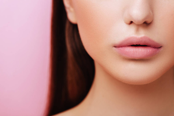 Lips of Beauty model with natural make up on pink background - 写真・画像
