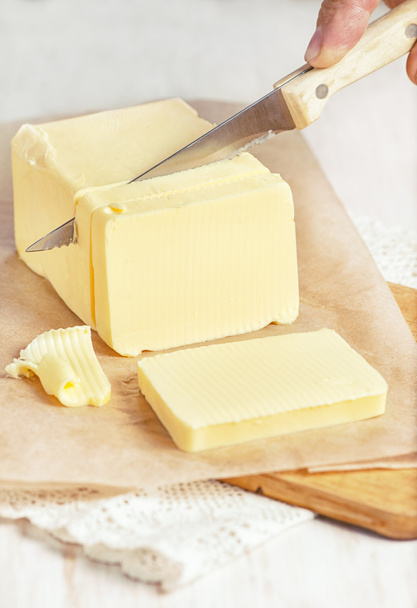 Butter cutting by knife - Foto, afbeelding