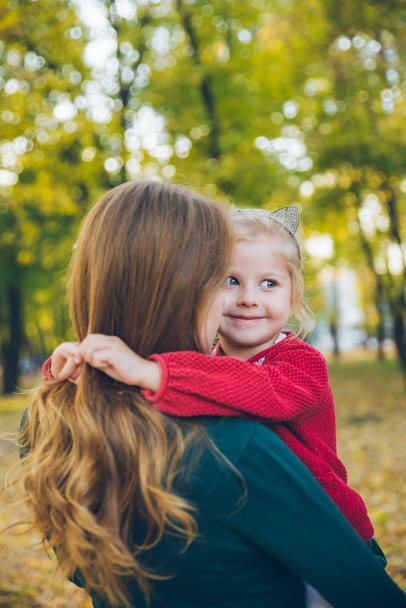 mother daughter love hug at autumn city park - Foto, Imagem