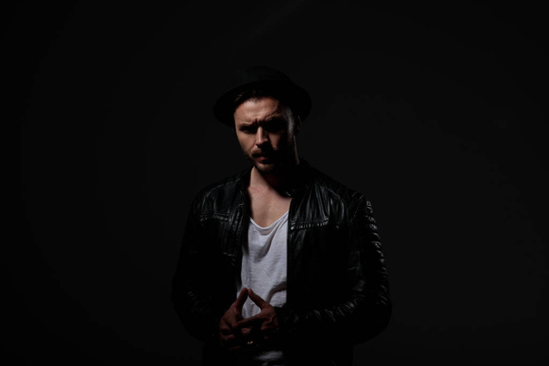 dramatic cool guy wearing leather jacket and hat - Photo, Image