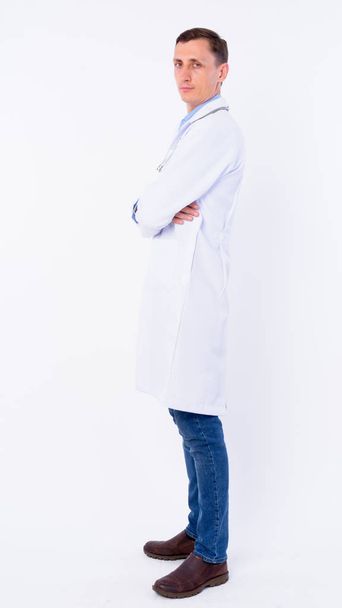Full body shot profile view of man doctor looking at camera - Fotoğraf, Görsel