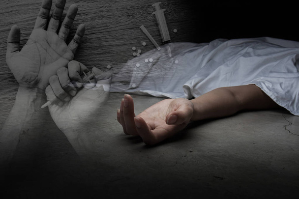 The dead woman's body. Focus on hand with drug background - Fotoğraf, Görsel