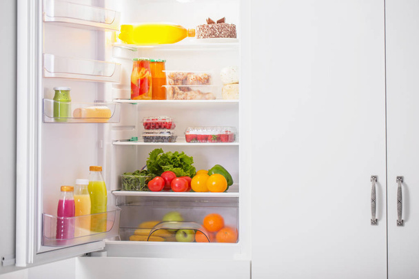  white fridge with different food - Valokuva, kuva