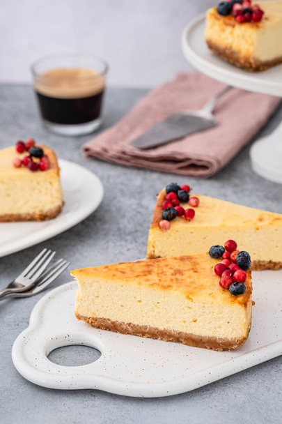 Classic cheesecake with berries and cup of espresso on gray background. - Foto, Imagem