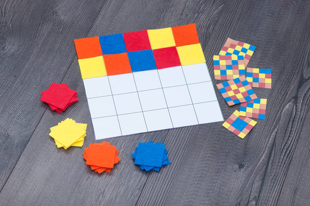 Kids education game at home. Colored textile squares put as same as in sample. - 写真・画像